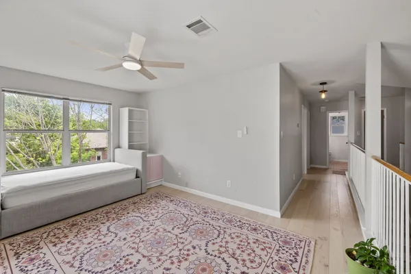 a bedroom with a bed and a window