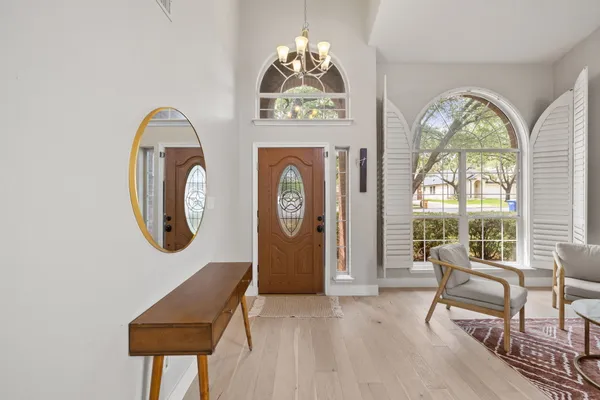 a view of a livingroom with furniture mirror and a window