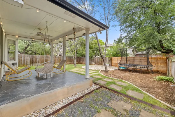 a view of house with a backyard