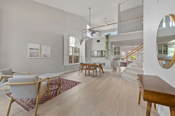 a living room with furniture and a wooden floor