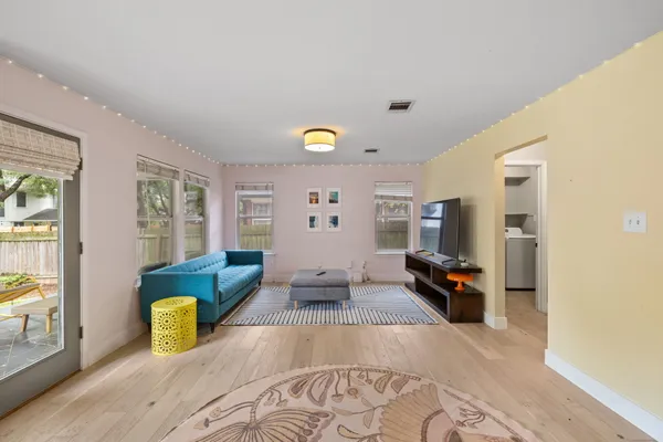 a view of living room with furniture and wooden floor
