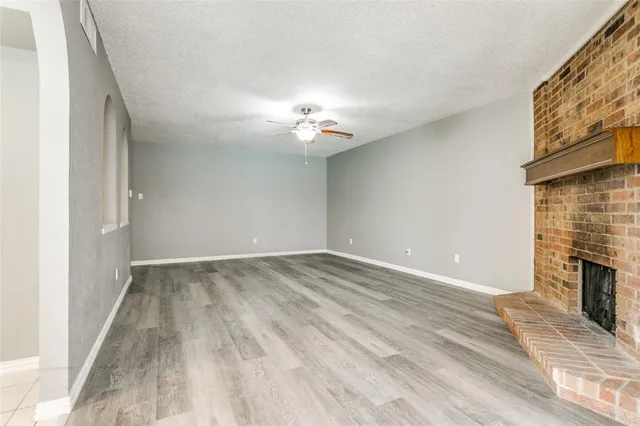 a view of empty room with a fireplace