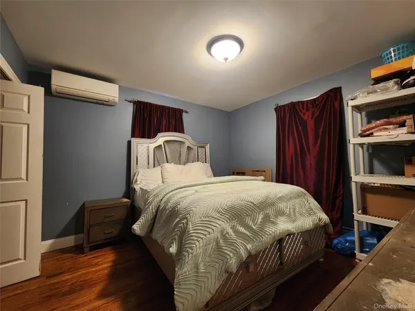a bedroom with a bed and a book shelf