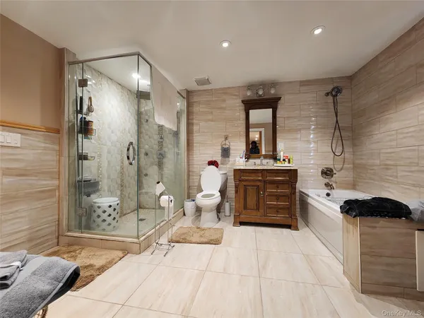 a bathroom with a double vanity sink toilet and shower