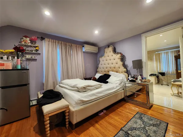 a bedroom with bed and a large mirror