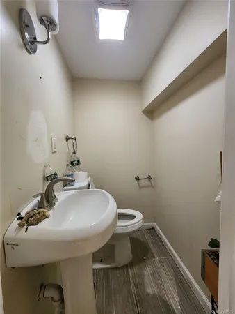 a bathroom with a sink toilet and a mirror