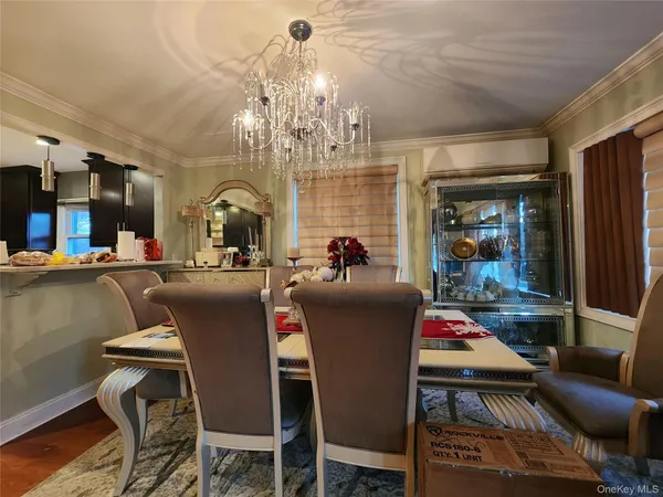 a dining room with furniture and chandelier or kitchen view