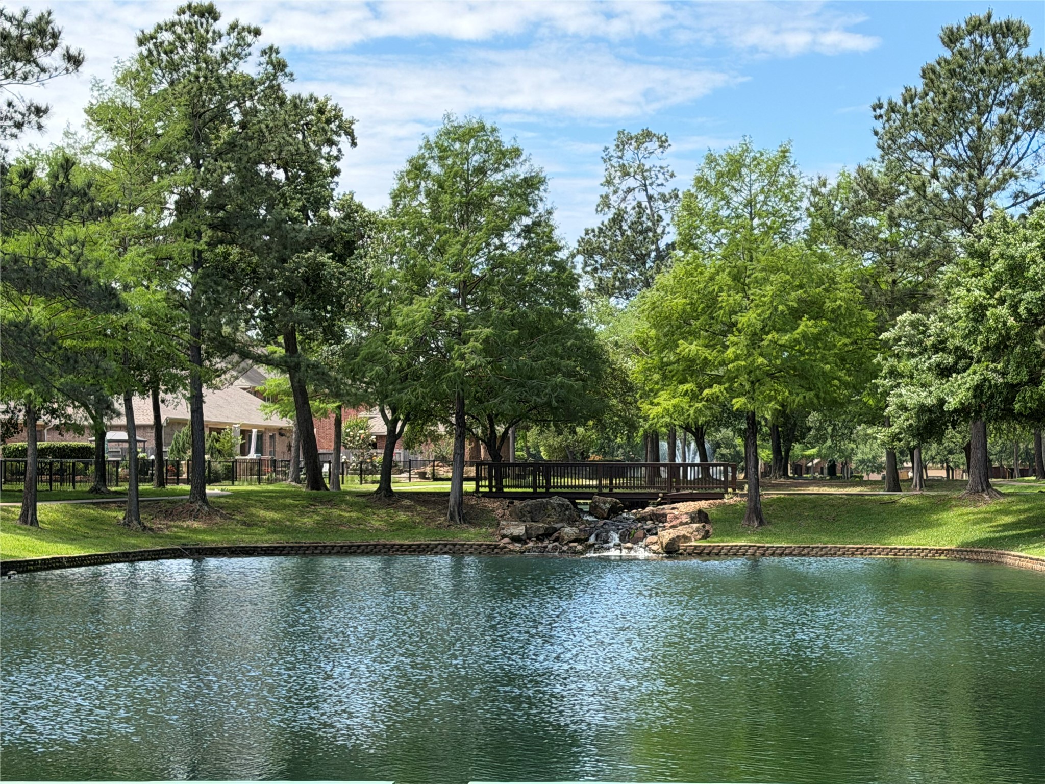 2406 Randal Point Court Spring, TX 77388 - Photo 42 of 45 Side view of the lake and waterfall pulling through the neighborhood to the home.