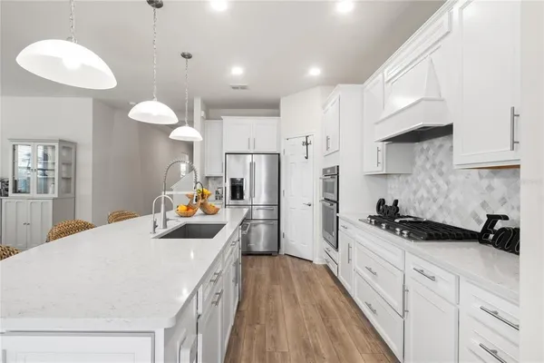 a kitchen with refrigerator and cabinets