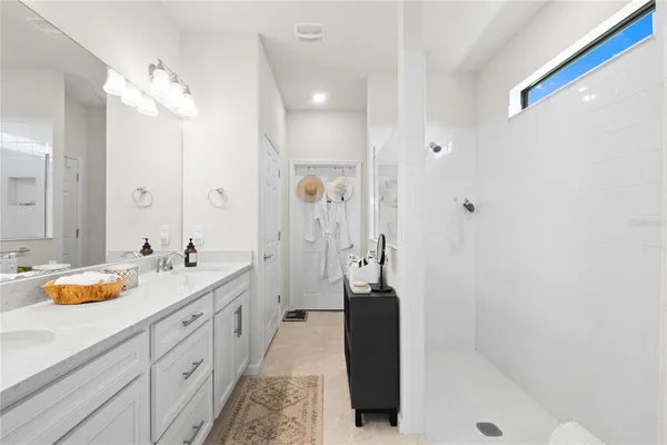 a bathroom with a tub sink and mirror