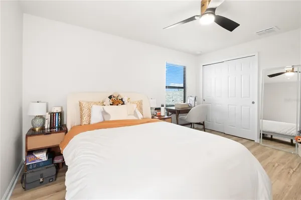 a bedroom with a bed and a chandelier