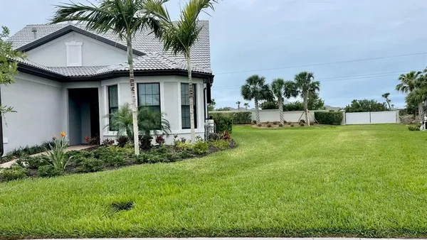 a view of a house with a yard and plants