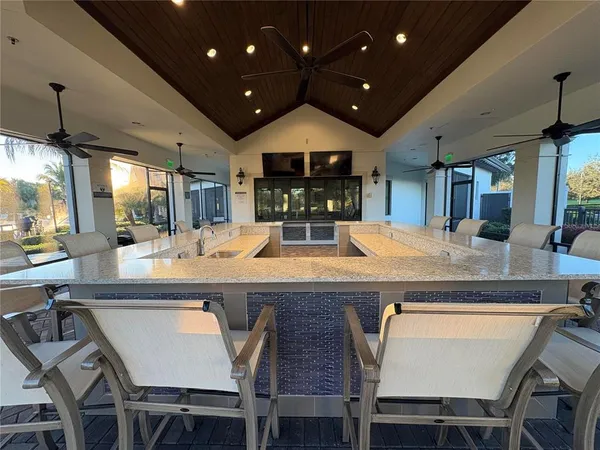 a kitchen with center island table and chairs