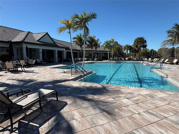 a view of a house with backyard and sitting area