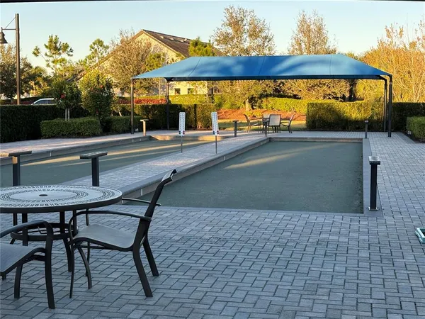 a view of a patio with table and chairs under an umbrella