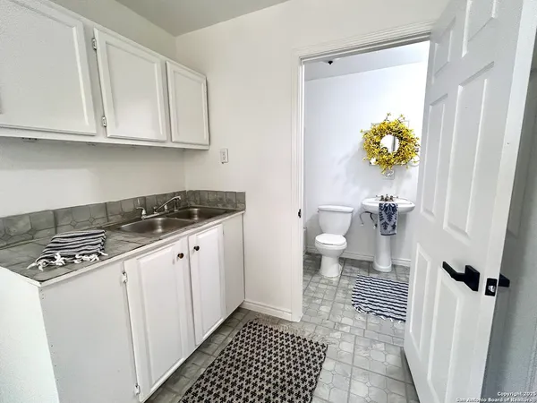 a kitchen with a sink and a stove top oven