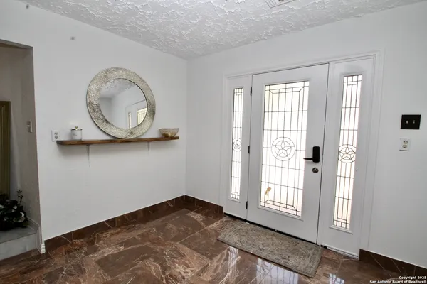 a view of a room with wooden floor and window