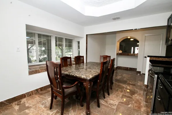a dining room with furniture and window