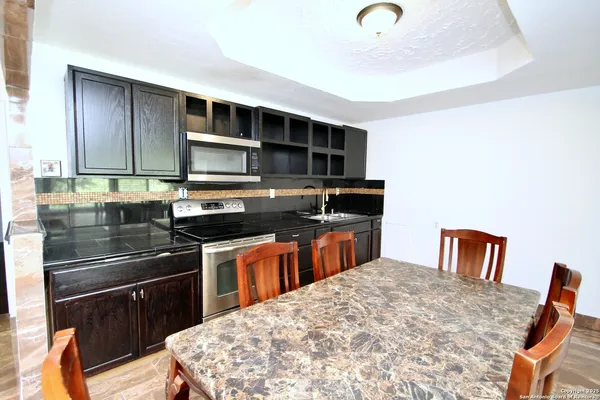 a kitchen with stainless steel appliances granite countertop a stove and a sink