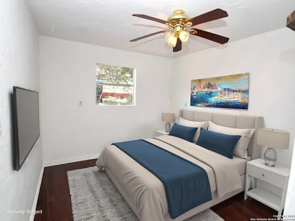a bedroom with a large bed and a chandelier