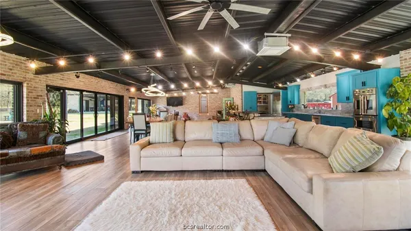 a living room with furniture and a chandelier