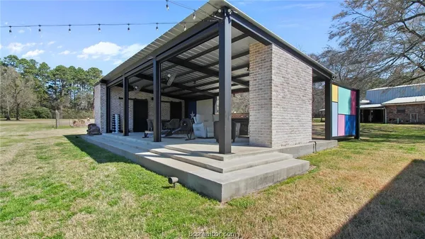 a view of a roof deck with table and chairs with wooden floor