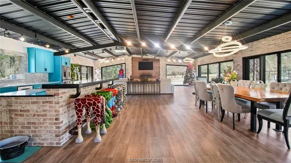 a view of a porch with furniture and wooden floors