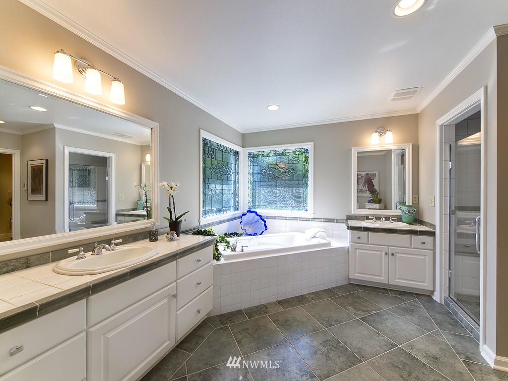 21800 Nootka Road Woodway, WA 98020 - Photo 11 of 15 a bathroom with a sink mirror and a bath tub