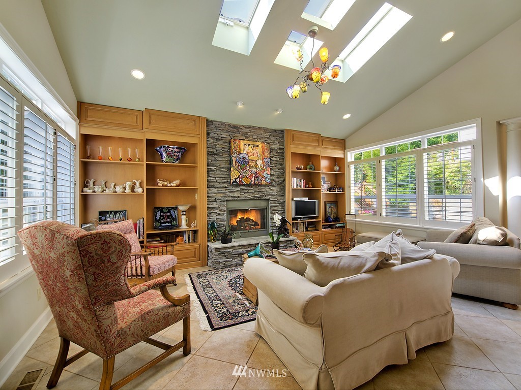 21800 Nootka Road Woodway, WA 98020 - Photo 7 of 15 a living room with fireplace furniture and a large window
