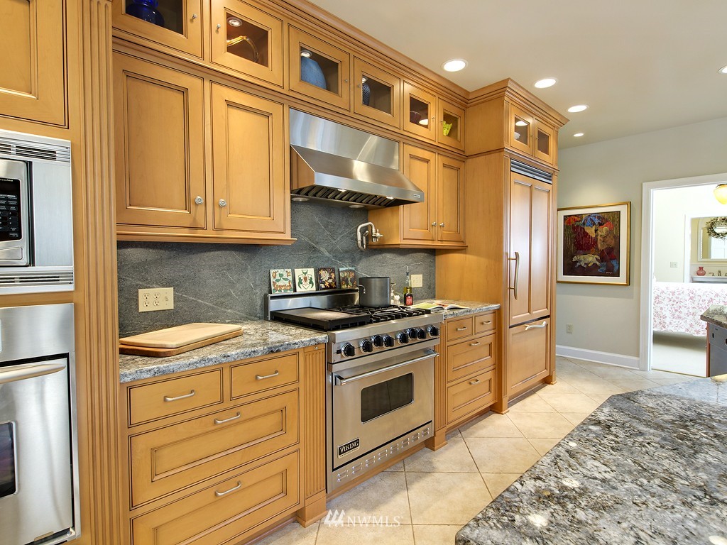 21800 Nootka Road Woodway, WA 98020 - Photo 8 of 15 a kitchen with stainless steel appliances granite countertop a stove and a refrigerator