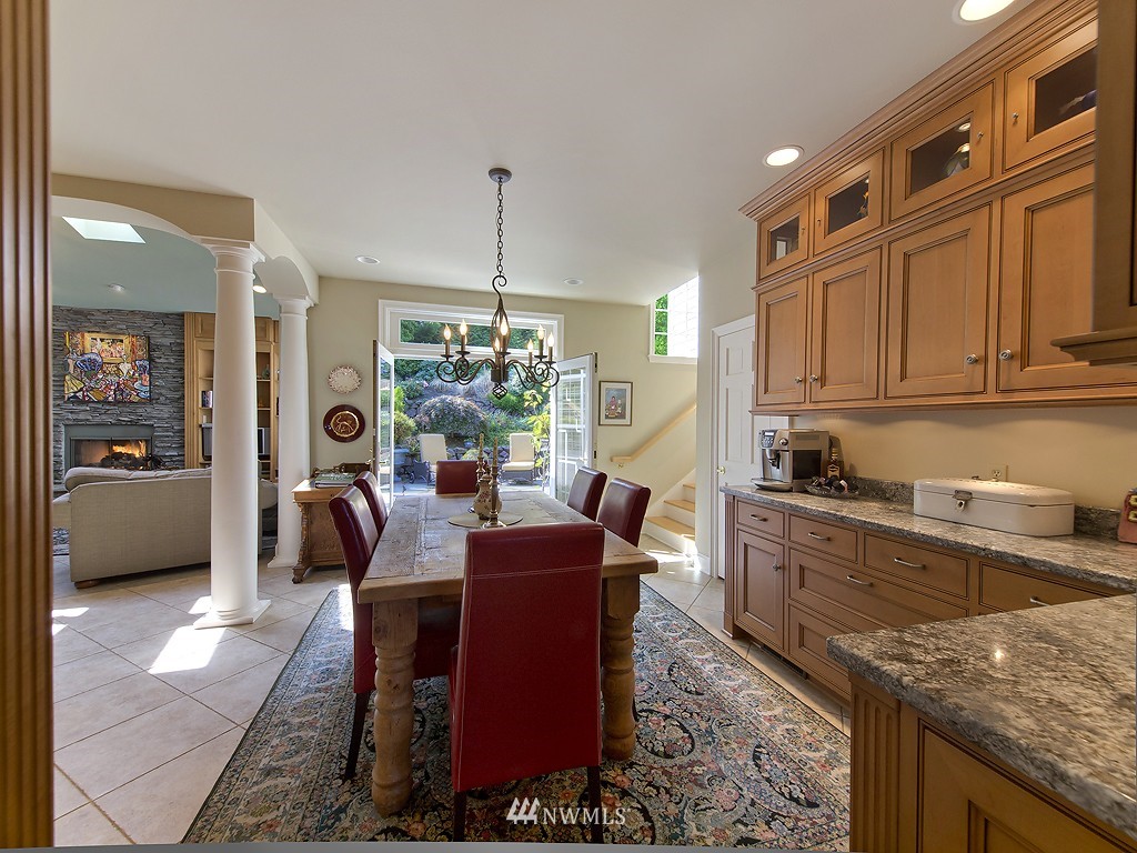 21800 Nootka Road Woodway, WA 98020 - Photo 9 of 15 a view of a kitchen and dining area with granite countertop furniture