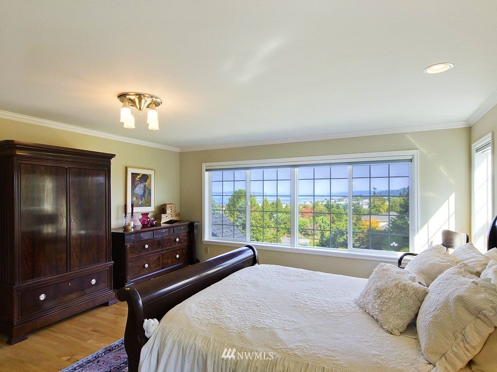 21800 Nootka Road Woodway, WA 98020 - Photo 10 of 15 a bedroom with a bed and large windows