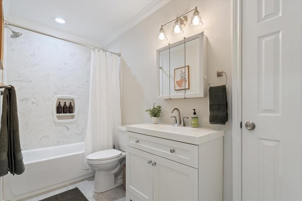 Undisclosed Address Waco, TX 76708 - Photo 18 of 30 Bathroom with vanity, ornamental molding, and shower / bath combo with shower curtain