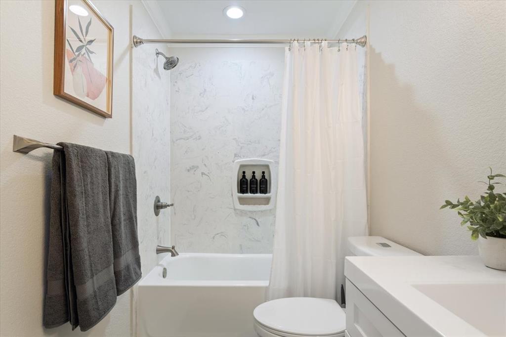Undisclosed Address Waco, TX 76708 - Photo 19 of 30 Bathroom with shower / bathtub combination with curtain, vanity, recessed lighting, and a textured wall