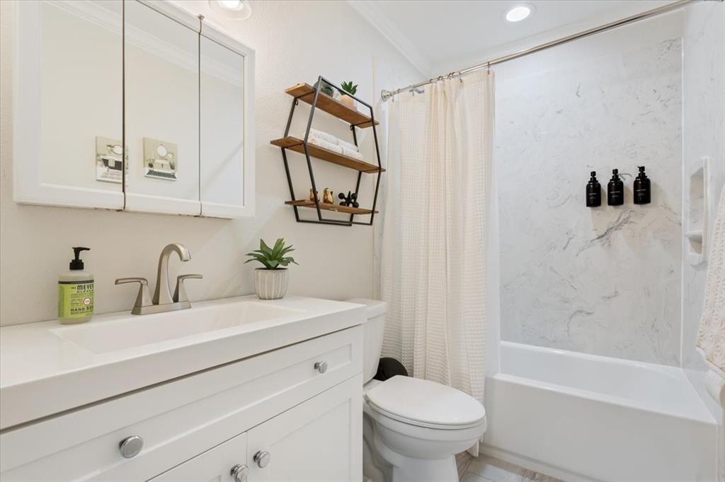 Undisclosed Address Waco, TX 76708 - Photo 23 of 30 Bathroom with vanity, shower / bathtub combination with curtain, and crown molding