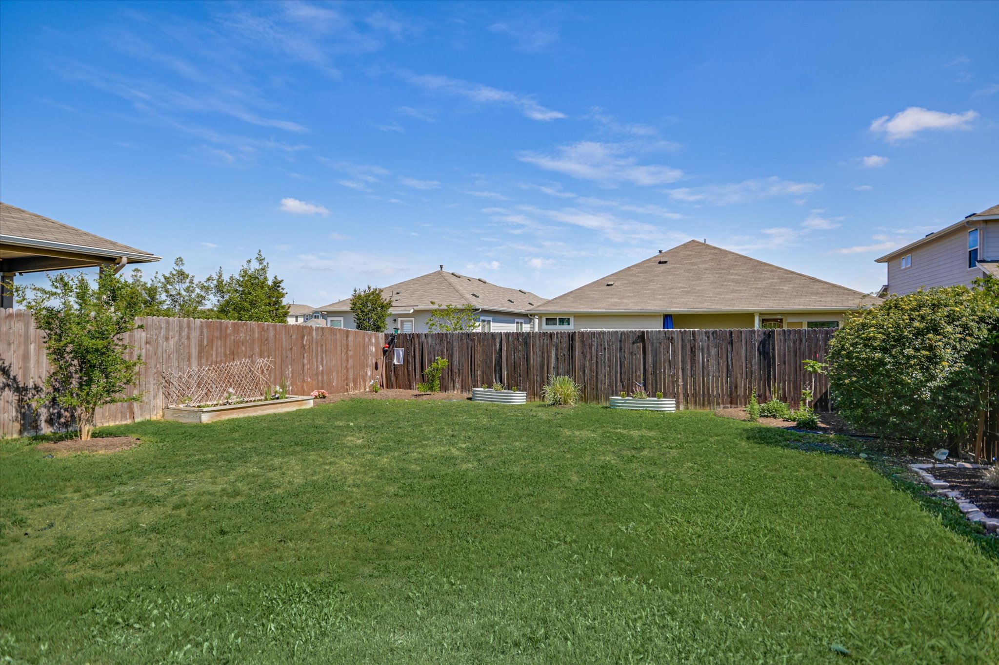 6304 Gunflint Drive Austin, TX 78747 - Photo 21 of 28 Raised garden beds, lush grass, and room to roam, a backyard that actually gets used.