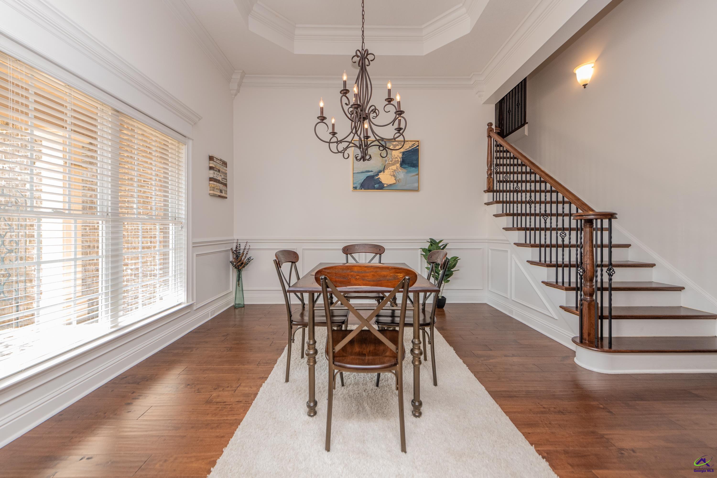 405 Old Bridge Road Warner Robins, GA 31088 - Photo 6 of 58 a view of a dining room with furniture wooden floor and a chandelier
