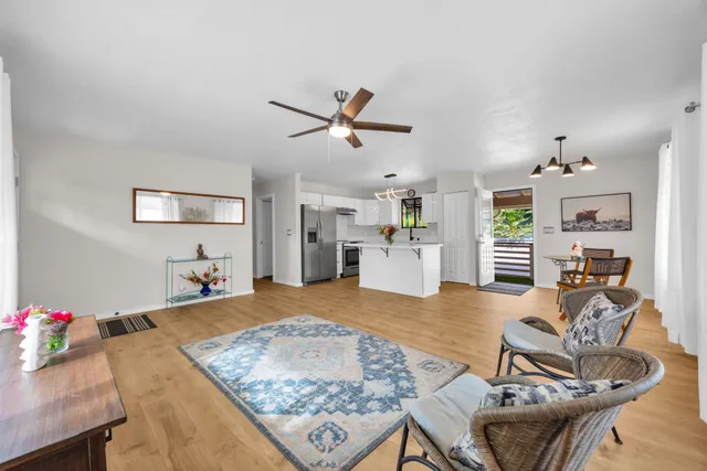 a living room with furniture and kitchen view