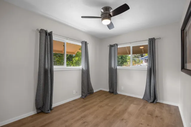 an empty room with window and stainless steel appliances