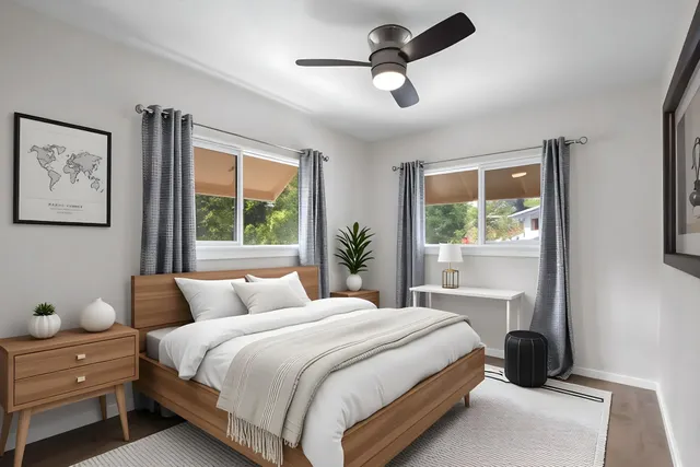 a bedroom with a large bed and a window