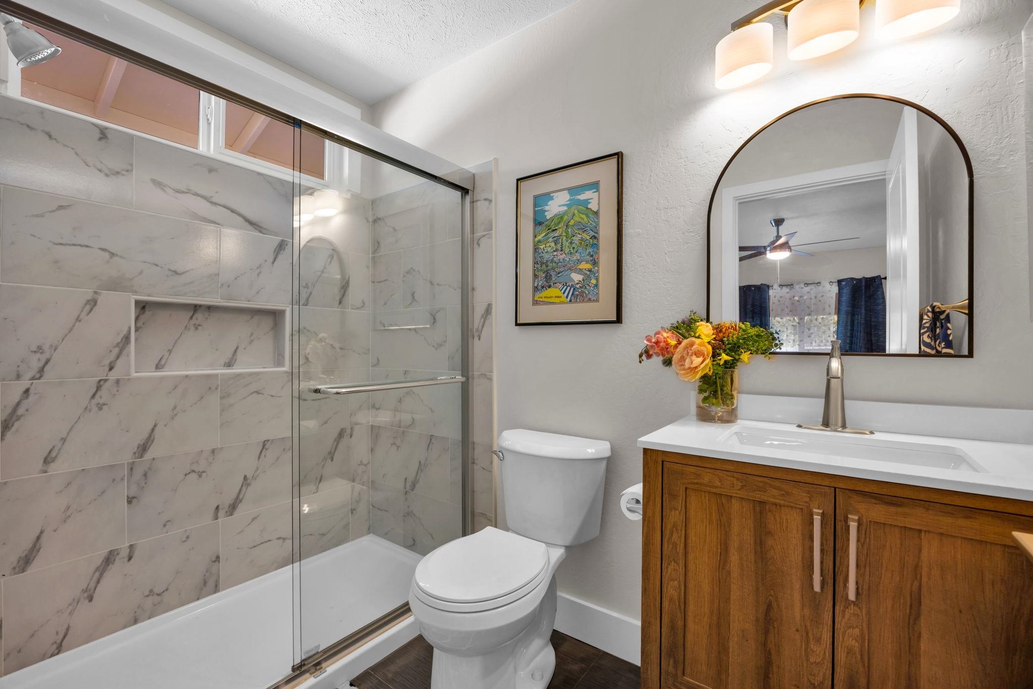 1702 Haiku Road, Unit B Haiku, HI 96708 - Photo 19 of 43 a bathroom with a granite countertop sink toilet and shower