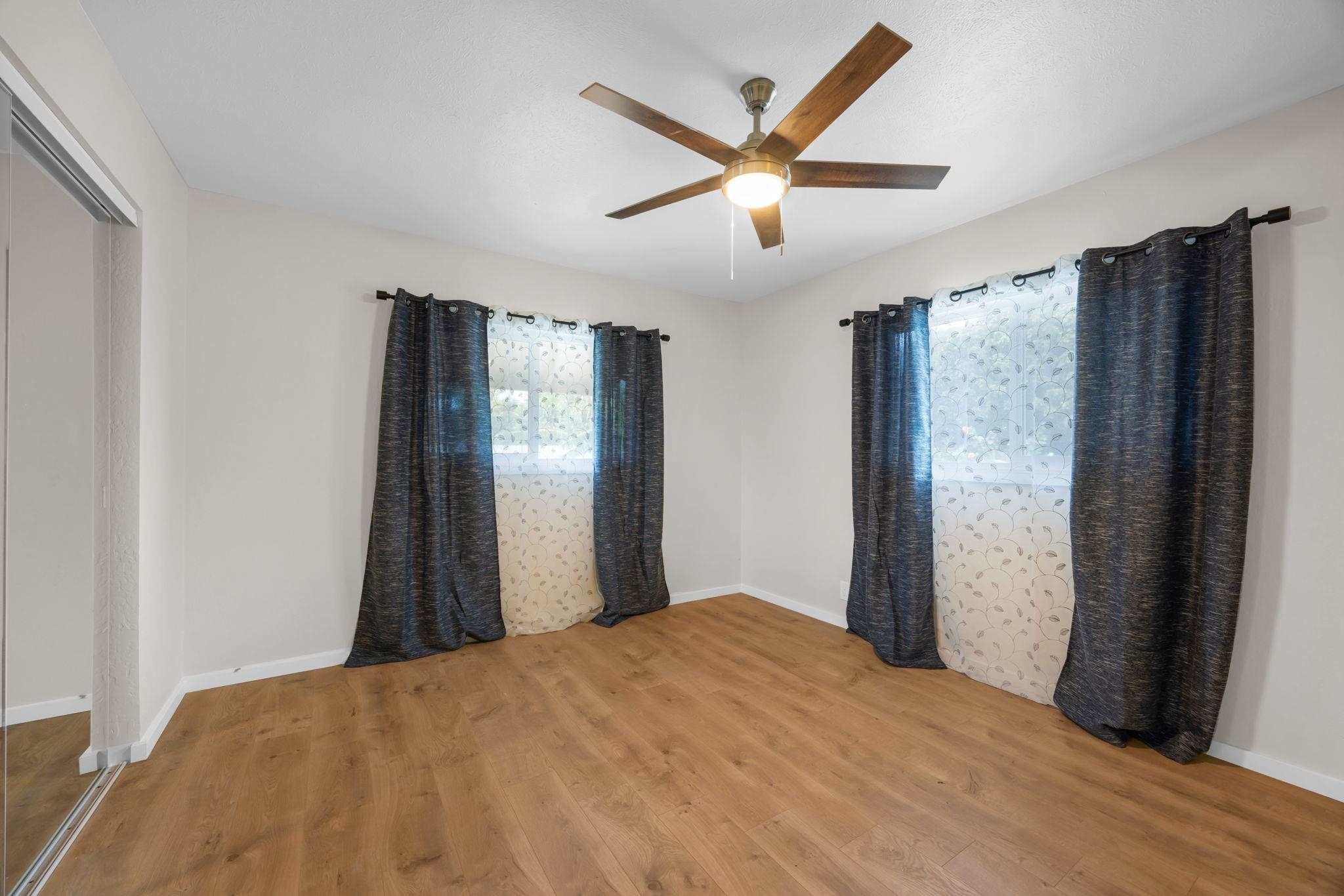 1702 Haiku Road, Unit B Haiku, HI 96708 - Photo 20 of 43 a bedroom with a large bed and a chandelier