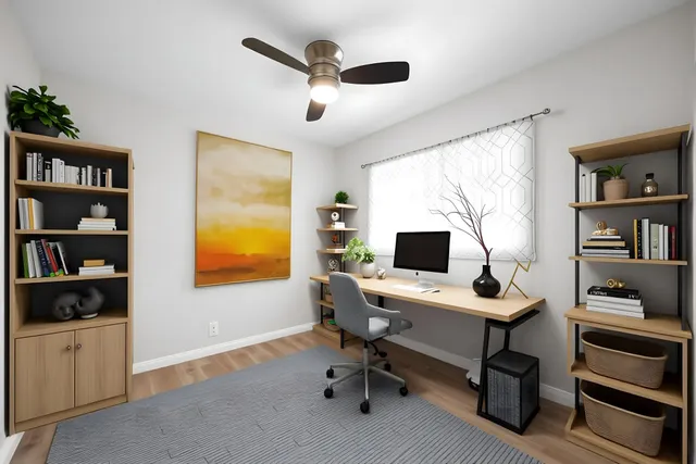 a view of a workspace with furniture and a bookshelf