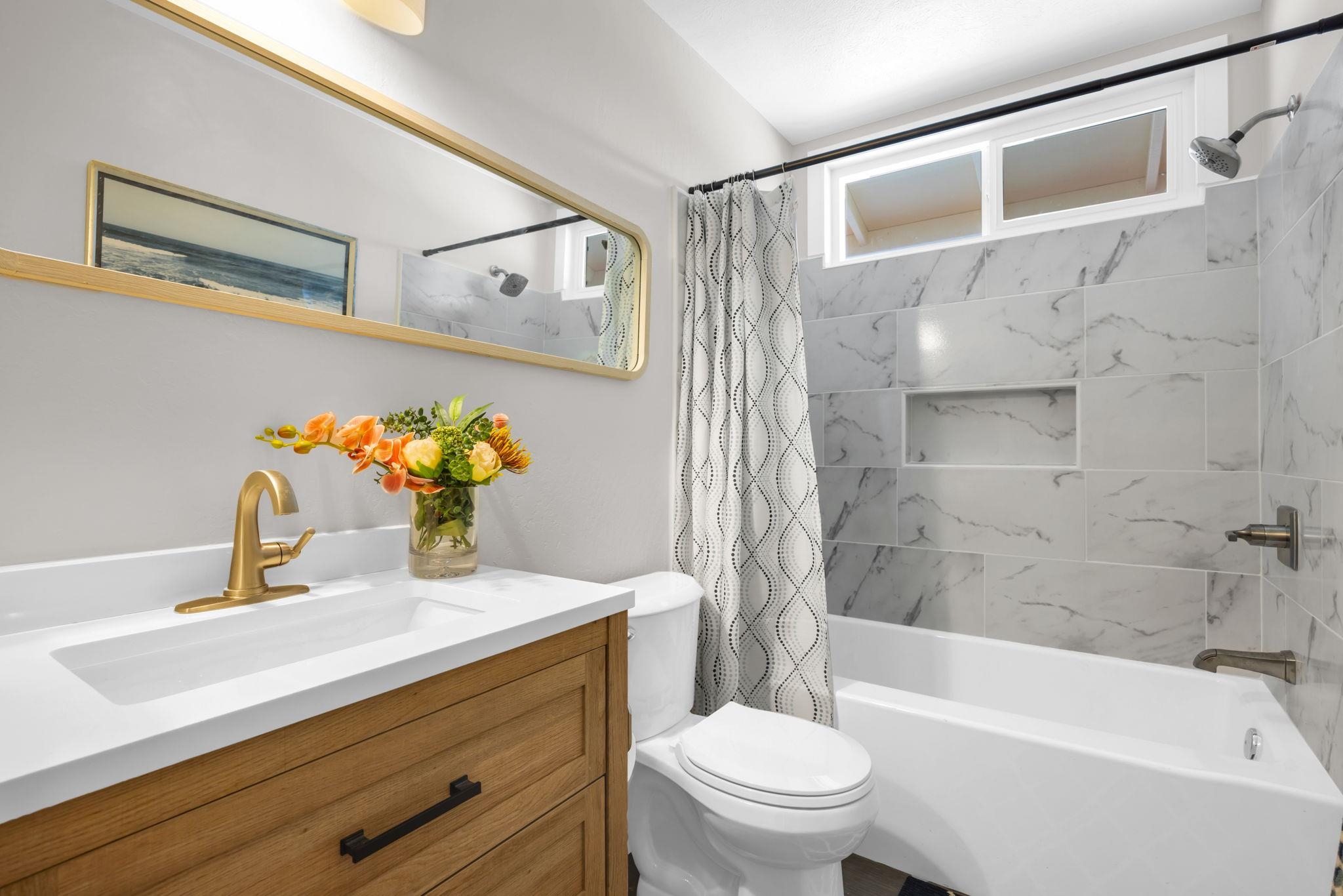 1702 Haiku Road, Unit B Haiku, HI 96708 - Photo 29 of 43 a bathroom with a sink mirror toilet and bathtub