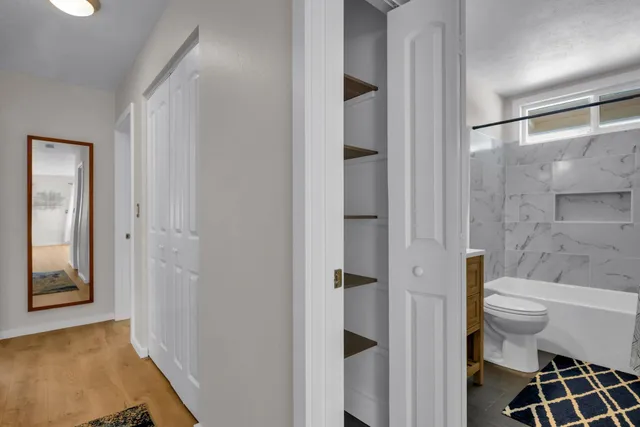 a bathroom with a toilet and a shower