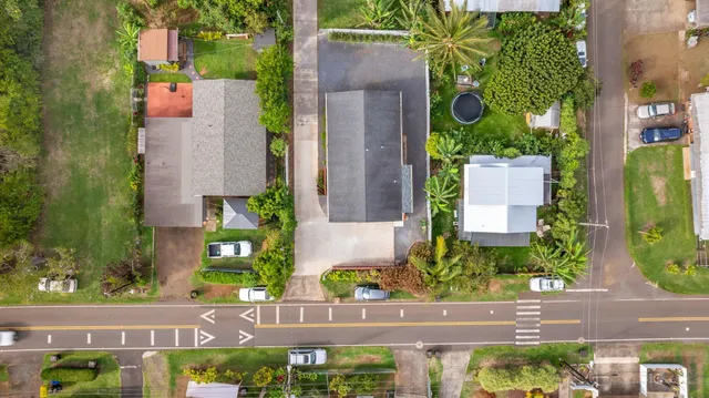 an aerial view of a house with a yard and garden