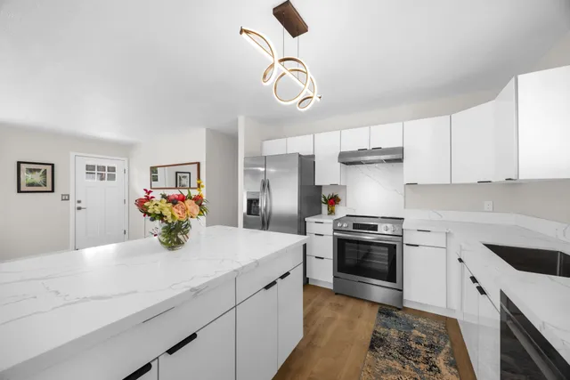 a kitchen with a sink appliances and cabinets