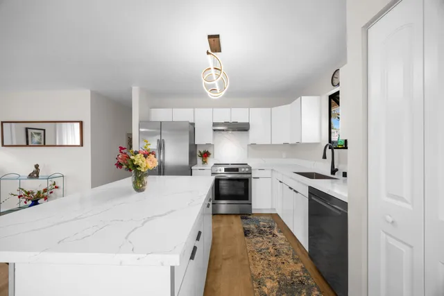 a kitchen with a white stove top oven and cabinets