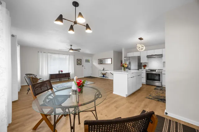 a living room with furniture and kitchen view