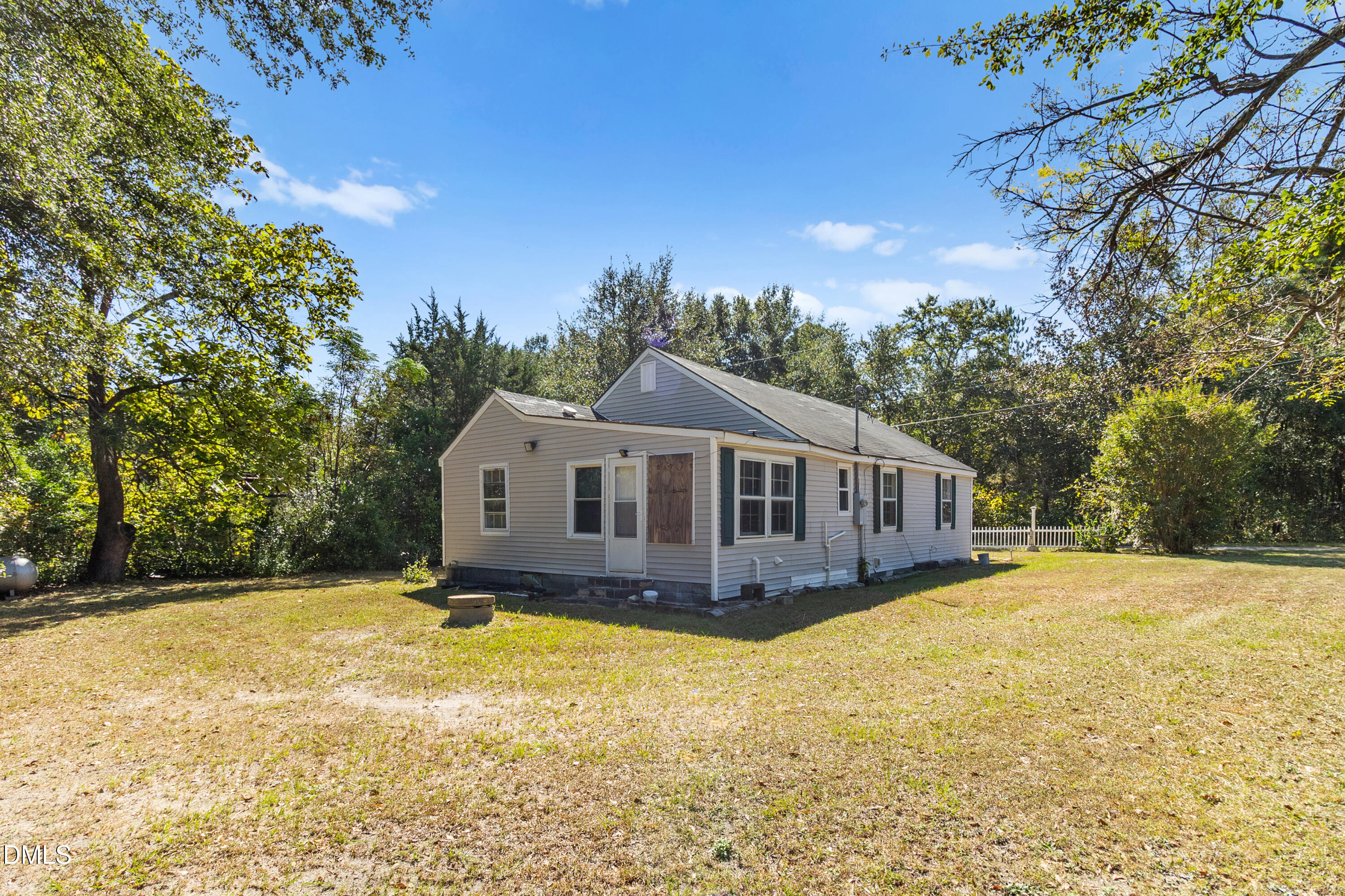 101 Doby Drive Raeford, NC 28376 - Photo 22 of 22 a front view of a house with a yard covered with trees